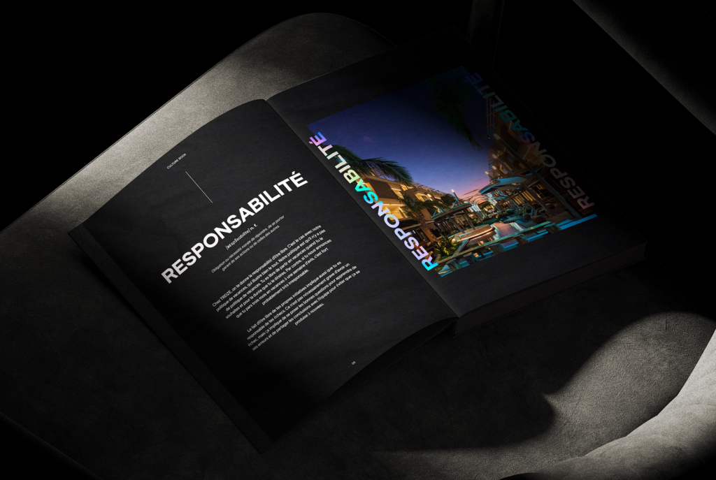 An open book on a dark chair displays a two-page spread; the left page features the word RESPONSABILITÉ in bold white letters with text below, while the right page shows a vibrant cityscape and the same word in colorful letters.